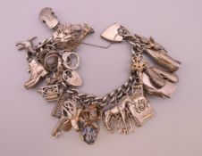 A silver charm bracelet. Approximately 17 cm long. 96.4 grammes total weight.