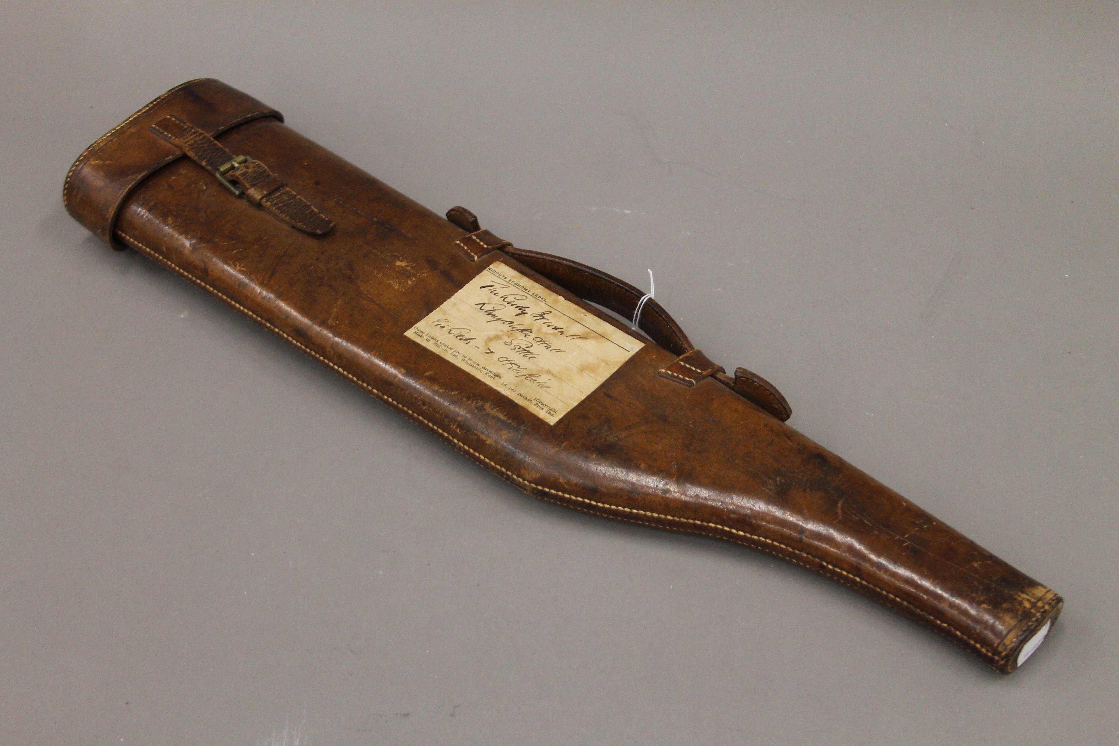 A small Victorian leather leg of mutton gun case with applied paper label,