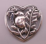 A silver heart shape with bird brooch. 3.5 cm high.