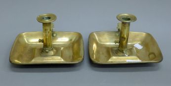 A pair of brass chamber sticks. 18 cm wide.