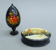 A Russian papier mache box and a papier mache egg. The former 11.5 cm wide.