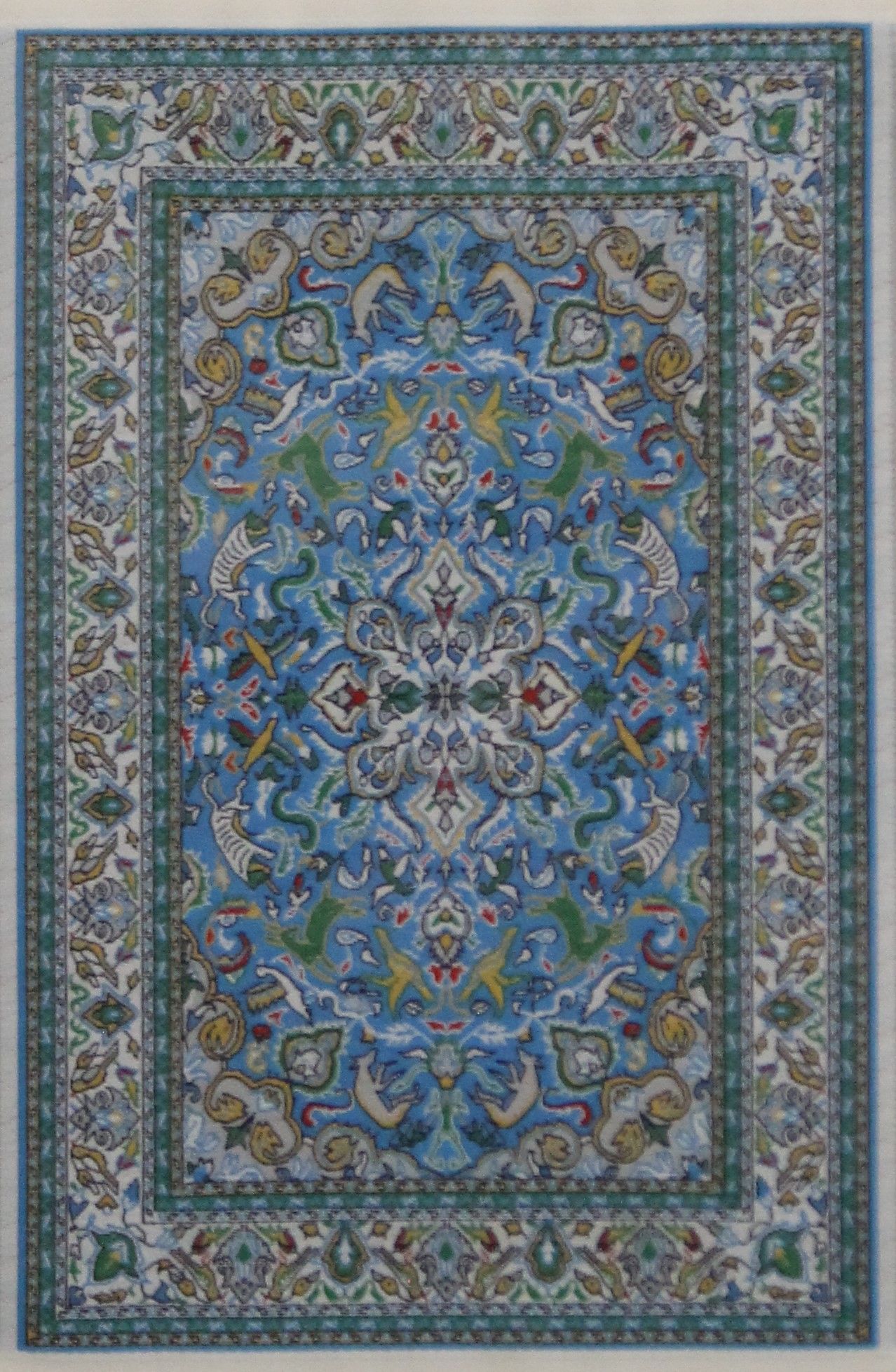 A miniature carpet, framed and glazed. 27.5 x 39 cm.