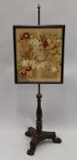 A Victorian tapestry inset pole screen. 145 cm high.