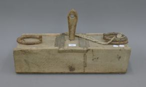 A primitive wooden animal trap. 61 cm long.