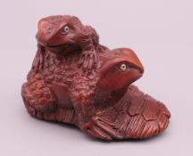 A netsuke in the form of two toads. 5.5 cm long.