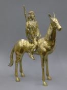 A brass figure of a Native American on horseback. 67.5 cm high.