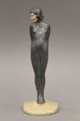 An Art Deco lead figure of a girl. 24 cm high.