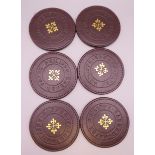 A set of six Patek Philippe coasters. 10 cm diameter.