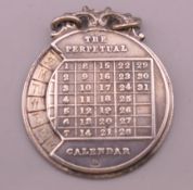 A silver perpetual calendar pendant. 2.5 cm diameter.