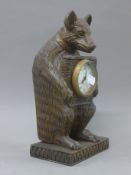 A carved bear formed clock. 30 cm high.