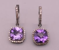 A pair of amethyst and diamond earrings. 3 cm high.