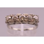 An unmarked white gold five stone diamond ring. Ring size O/P.