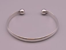 A silver torque bangle. 7.5 cm internal diameter. 31.6 grammes.