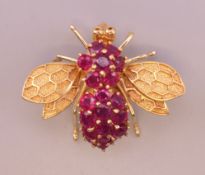 A 14 ct gold and ruby bee form brooch. 2.5 cm long. 6.8 grammes total weight.