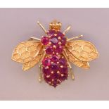 A 14 ct gold and ruby bee form brooch. 2.5 cm long. 6.8 grammes total weight.