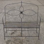 A wrought iron garden bench. 111 cm wide.