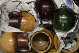 A quantity of stoneware jugs, crocks, and two glass floats.