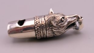 A silver fox head form whistle. 3.5 cm long excluding suspension loop.