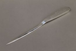 A boxed silver letter opener with presentation inscription. 26.5 cm long.