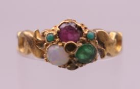 A Victorian unmarked gold opal, ruby and emerald ring. Ring size L/M. 2.2 grammes total weight.