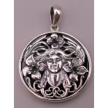 A sterling silver Art Nouveau style pendant. 3.25 cm diameter.