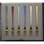 A cased set of six Danish silver gilt and enamel forks. Each 10 cm long.