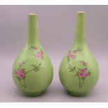 A pair of 19th century Chinese green ground porcelain vases decorated with floral sprays. 17.