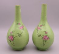 A pair of 19th century Chinese green ground porcelain vases decorated with floral sprays. 17.