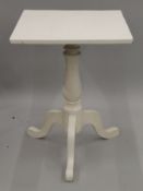 A white painted tripod table. 56 cm wide.