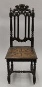 A Victorian single carved oak chair.