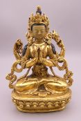 A gilt bronze model of a multi-armed deity with painted face. 14.5 cm high.