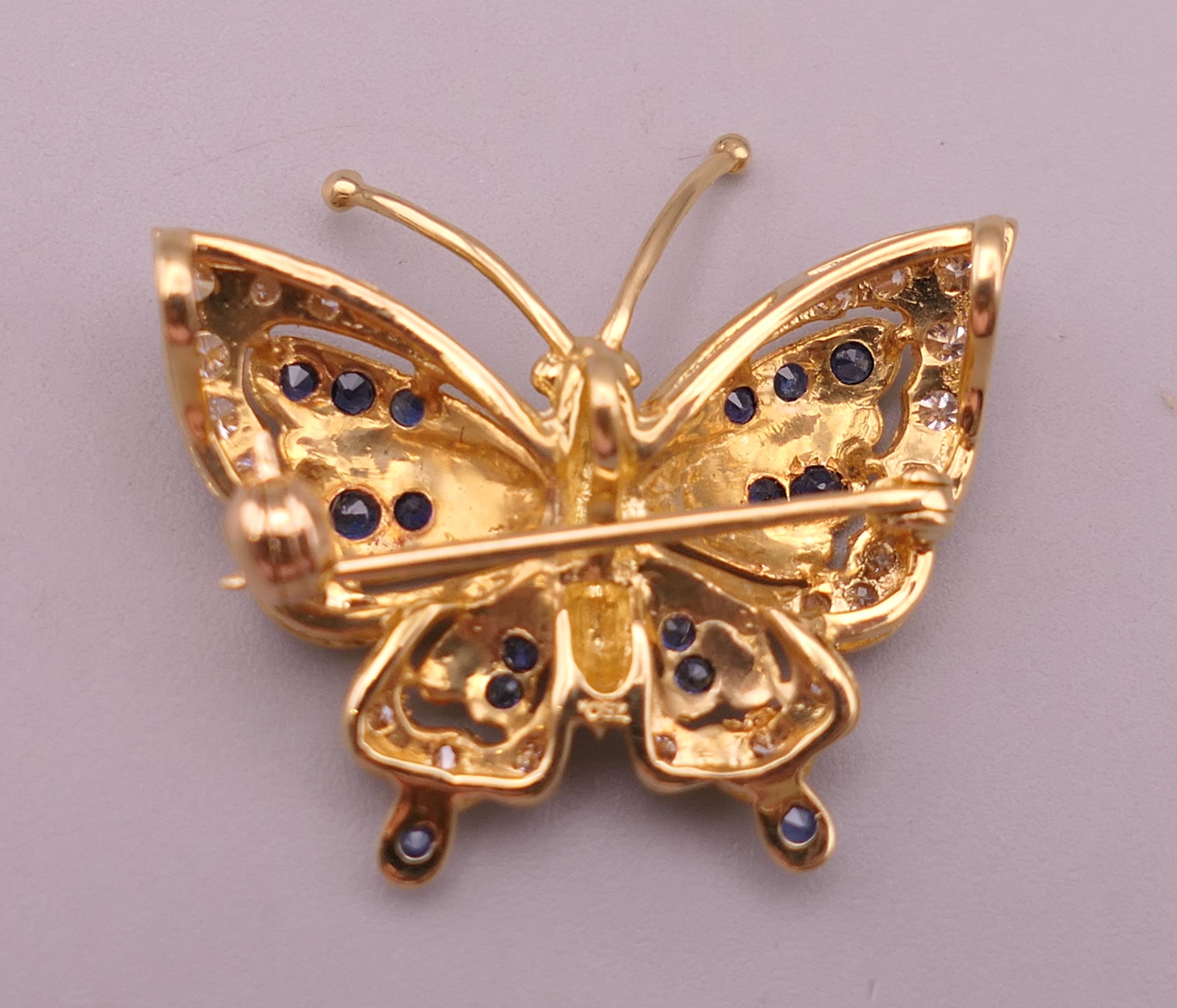 An 18 ct gold, diamond and sapphire butterfly form brooch. 2.5 cm wide. 4.7 grammes total weight. - Image 2 of 7