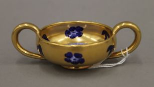 A Coalport porcelain gilt heightened blue and white twin handled vessel. 9 cm wide.