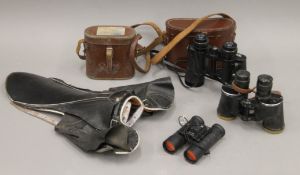A quantity of binoculars and a jockey's saddle.