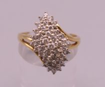 An 18 ct gold diamond cluster ring. Ring size Q/R. 6 grammes total weight.