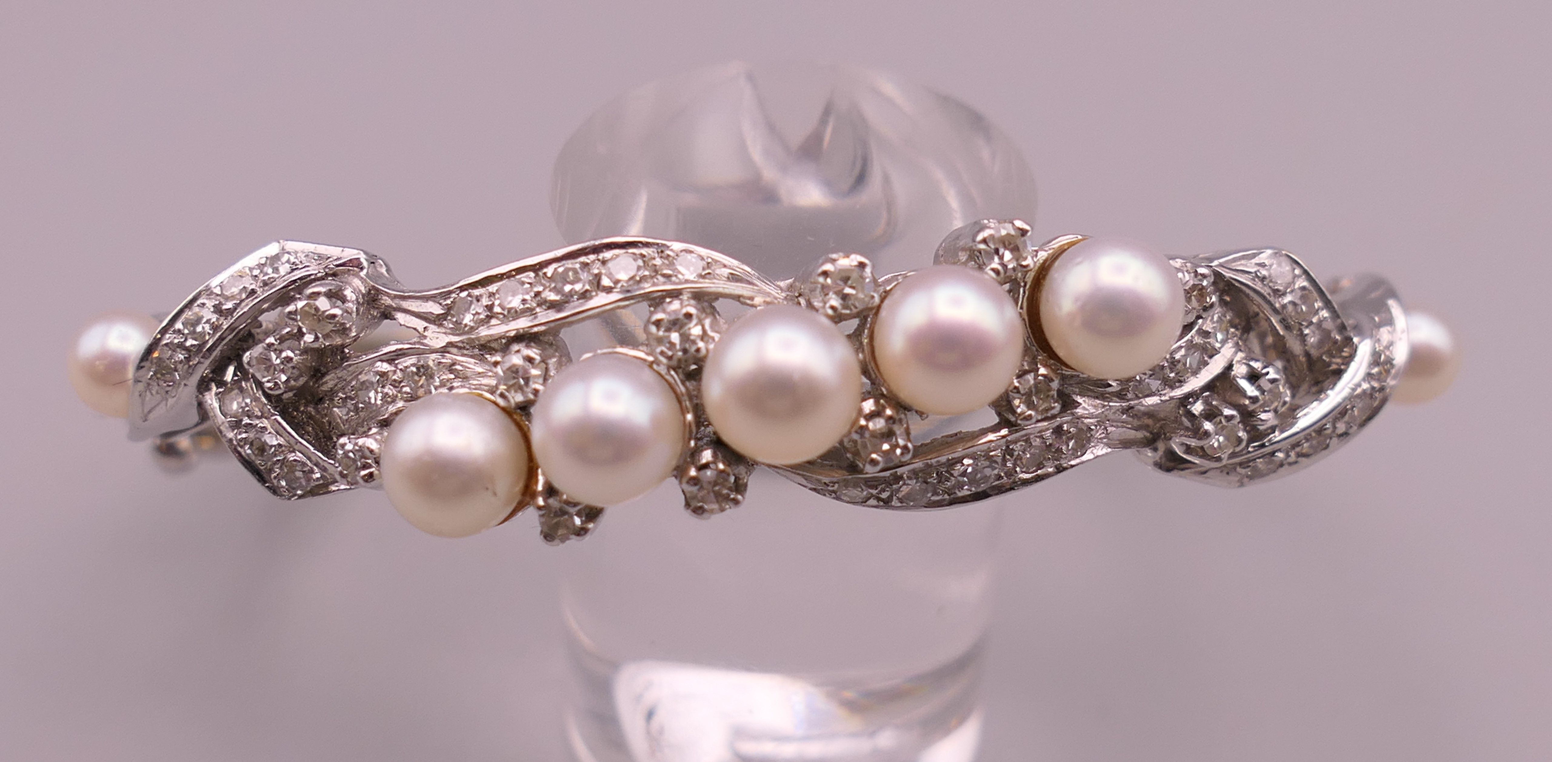 A 14 K white gold diamond and pearl bangle. 5 cm internal diameter. 16.5 grammes total weight. - Image 3 of 7