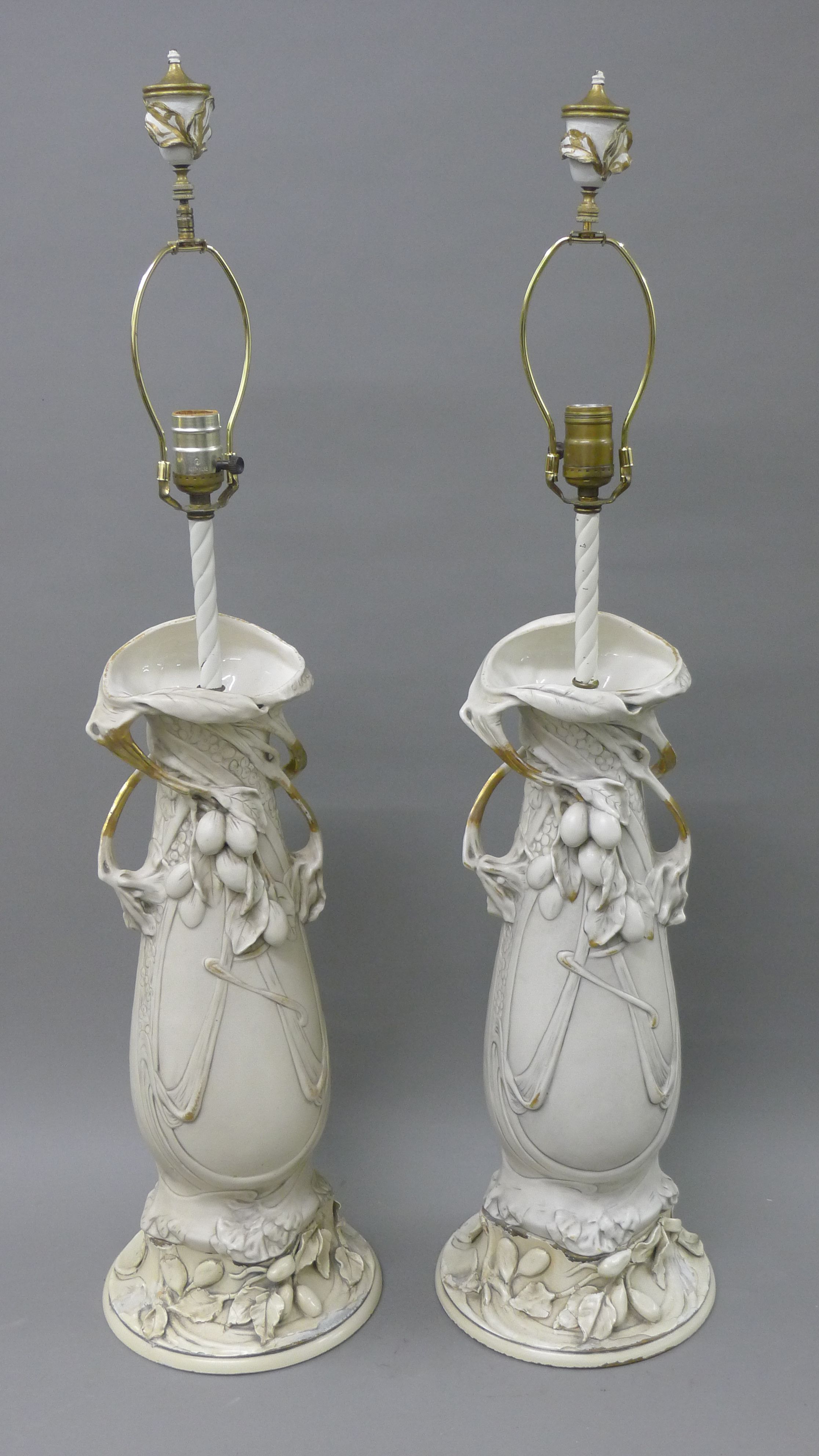 A pair of porcelain, possibly Royal Dux lamps. 89 cm high.