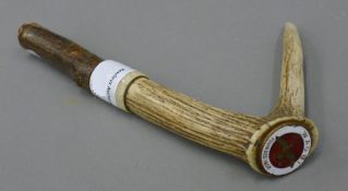 A WAGBI enamel badge, mounted on an antler walking stick handle.