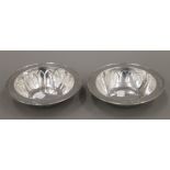 A pair of silver dishes, with embossed fruit decoration. Each approximately 16 cm diameter. 11.