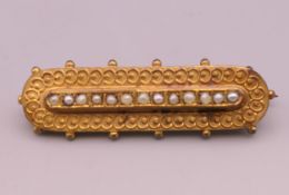 A 9 ct gold seed pearl set brooch. 4.5 cm long. 3.4 grammes total weight.