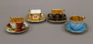 Four Coalport porcelain cabinet cups and saucers. The largest cup 4 cm high.