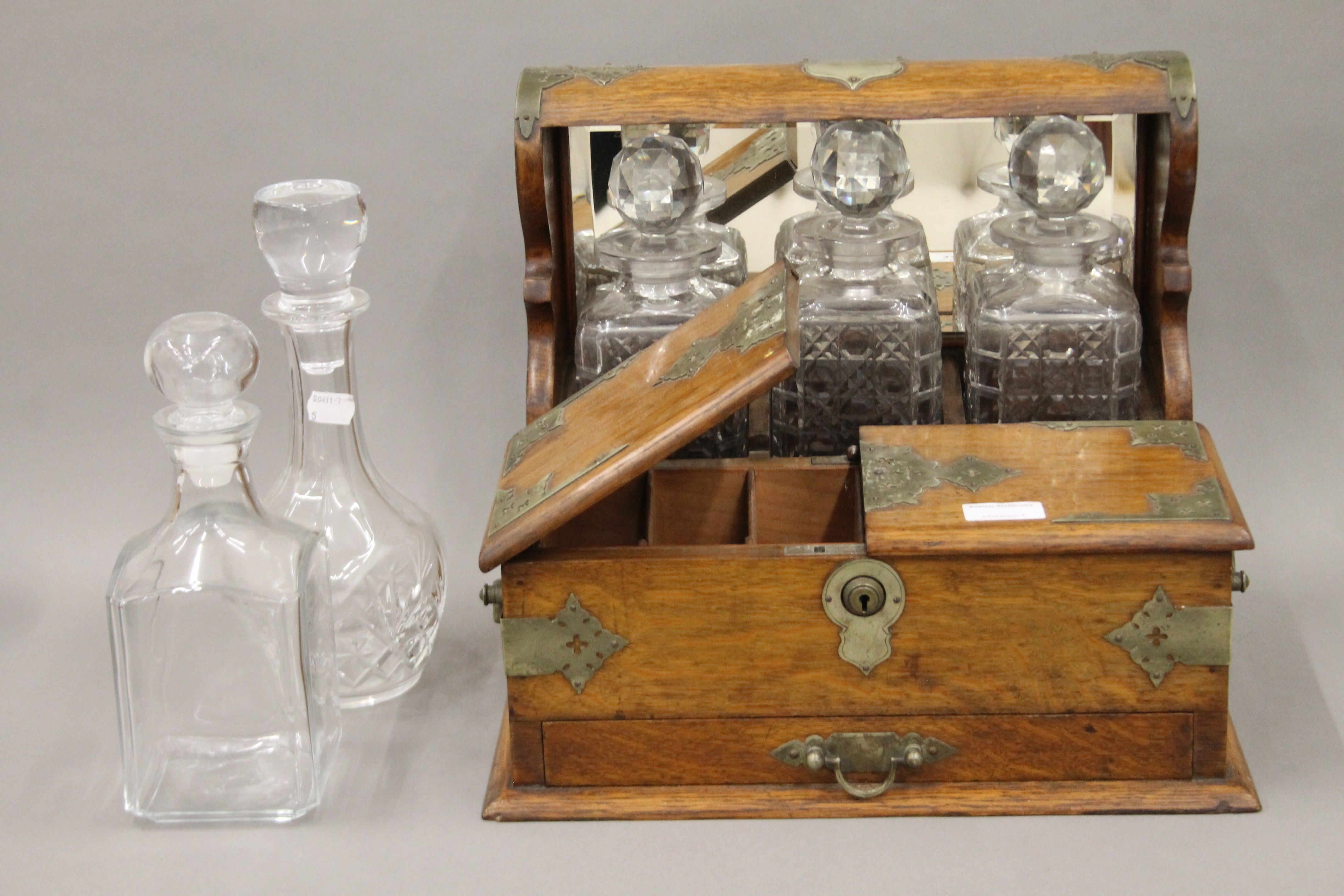 A Victorian silver plate mounted oak games box tantalus. 37 cm wide.