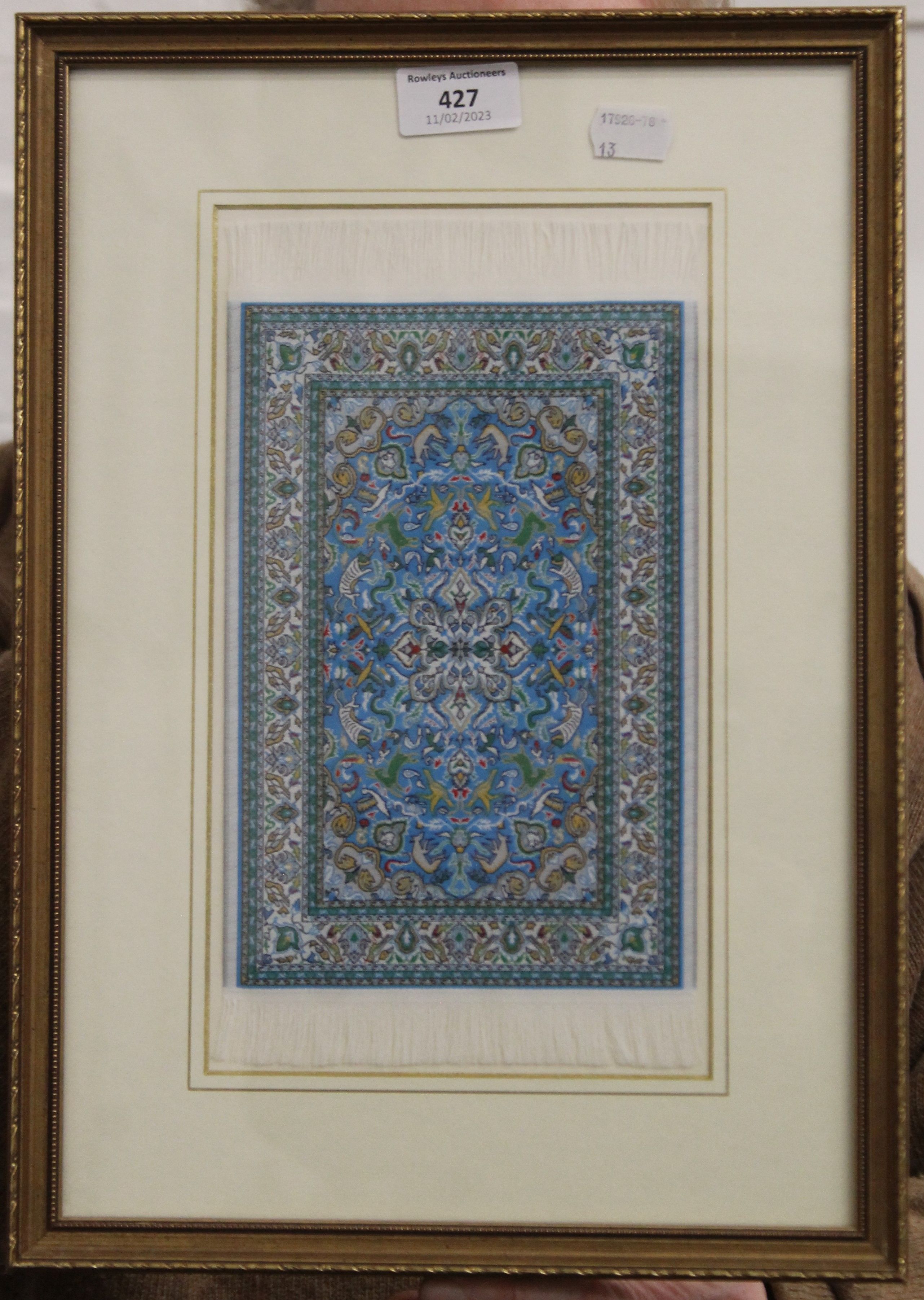 A miniature carpet, framed and glazed. 27.5 x 39 cm. - Image 2 of 2