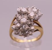 An 18 K gold diamond cluster ring. Ring size M. 8.1 grammes total weight.