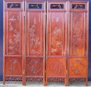 An Oriental four section carved wooden screen. 182 cm high x approximately 180 cm wide.