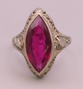 A 10 K white gold marquise shape synthetic ruby ring. Ring size K. 2.2 grammes total weight.