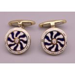 A pair of 18 ct gold diamond set enamel cufflinks. 1.5 cm diameter. 10.8 grammes total weight.