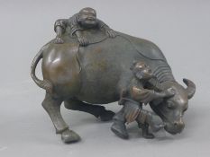 A bronze model of a bull and boys. 17 cm long.