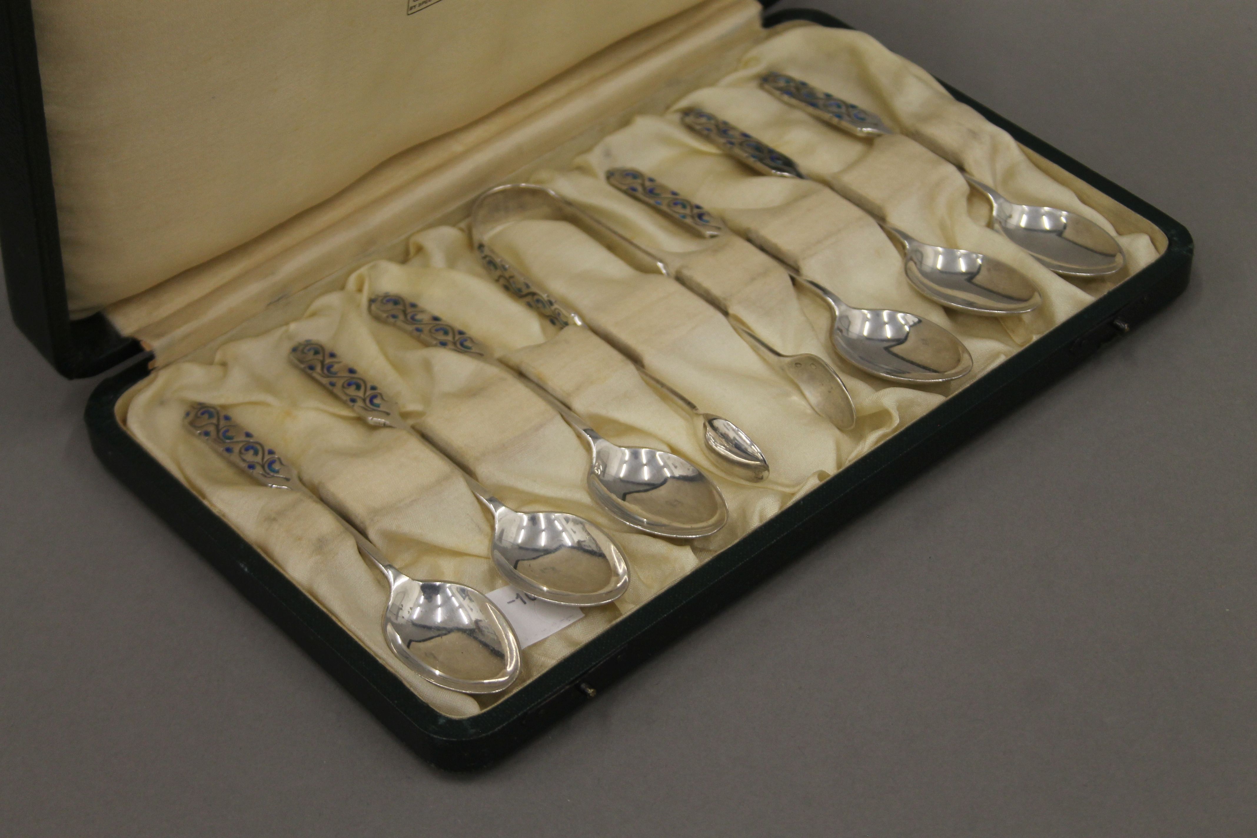 A boxed set of six Liberty and Co enamelled decorated silver teaspoons and matching tongs. - Image 5 of 5