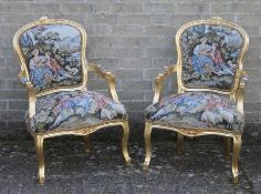 A pair of gilt framed tapestry armchairs. 60 cm wide.